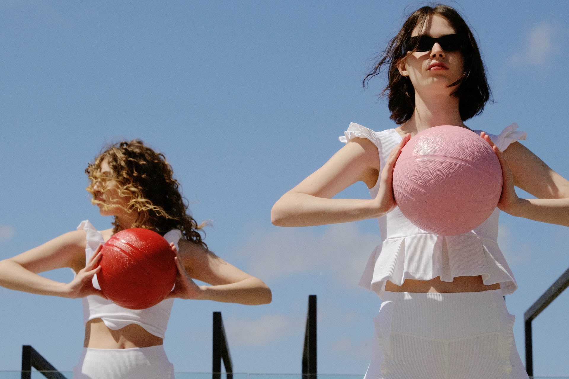 Two woman wearing white activewear tops